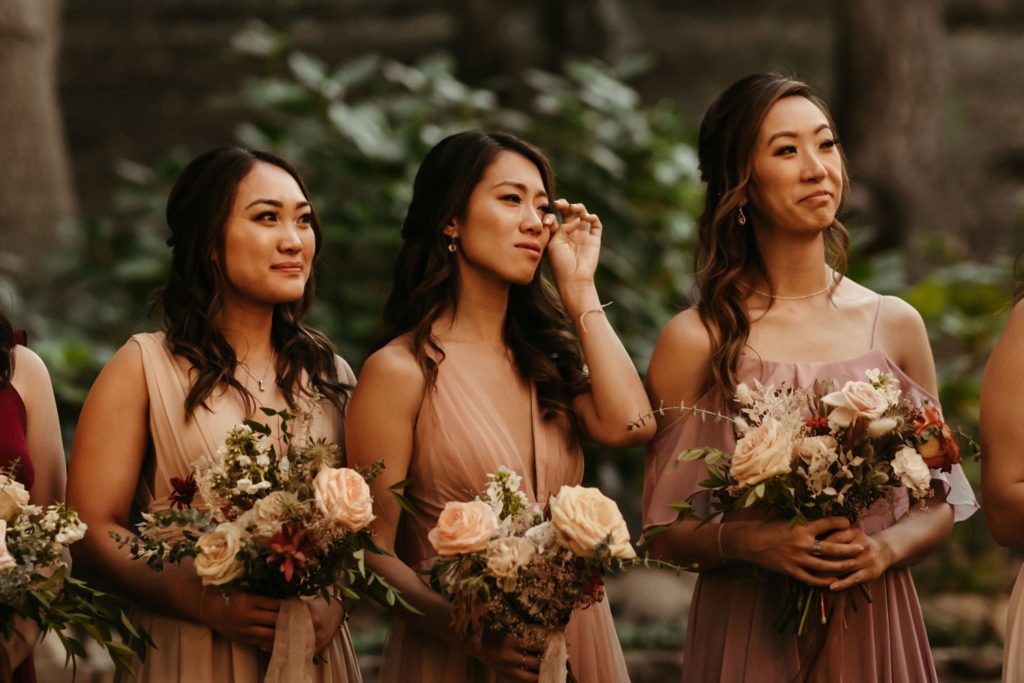 emotional bridesmaids during wedding ceremony