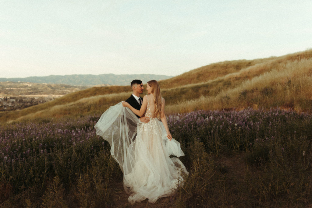fun candid elopement day at sunrise in some lupine fields