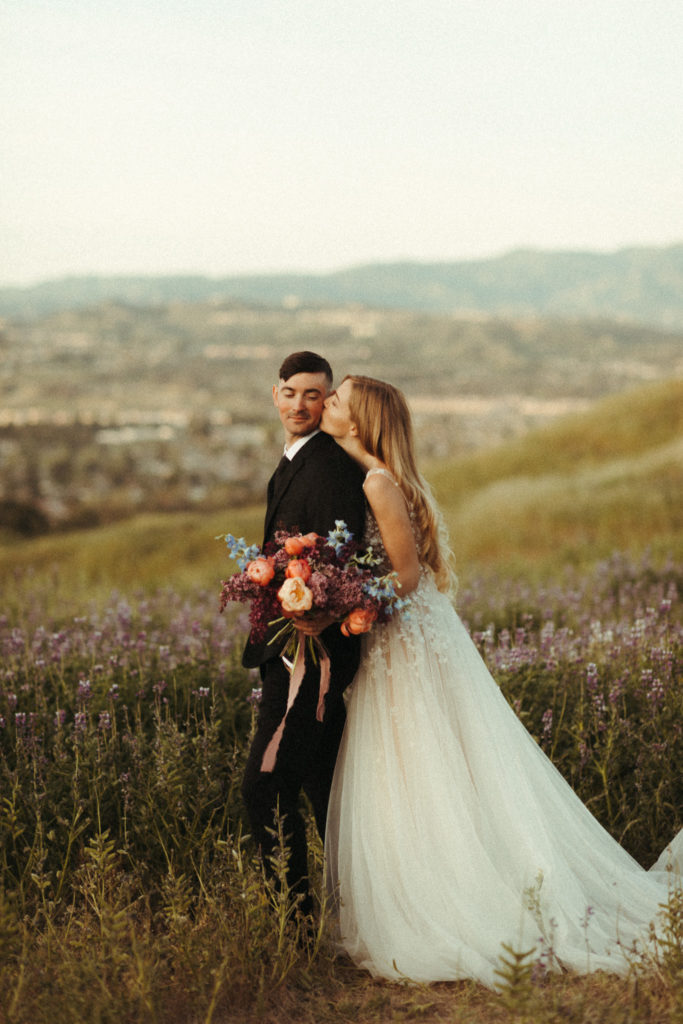 fun candid elopement day at sunrise in some lupine fields