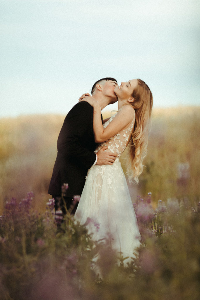 beautiful bride and groom in the lupine fields for their sunrise elopement