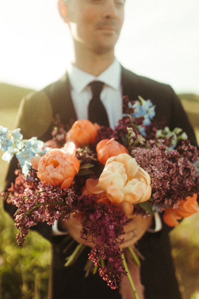 groom holding bouquet