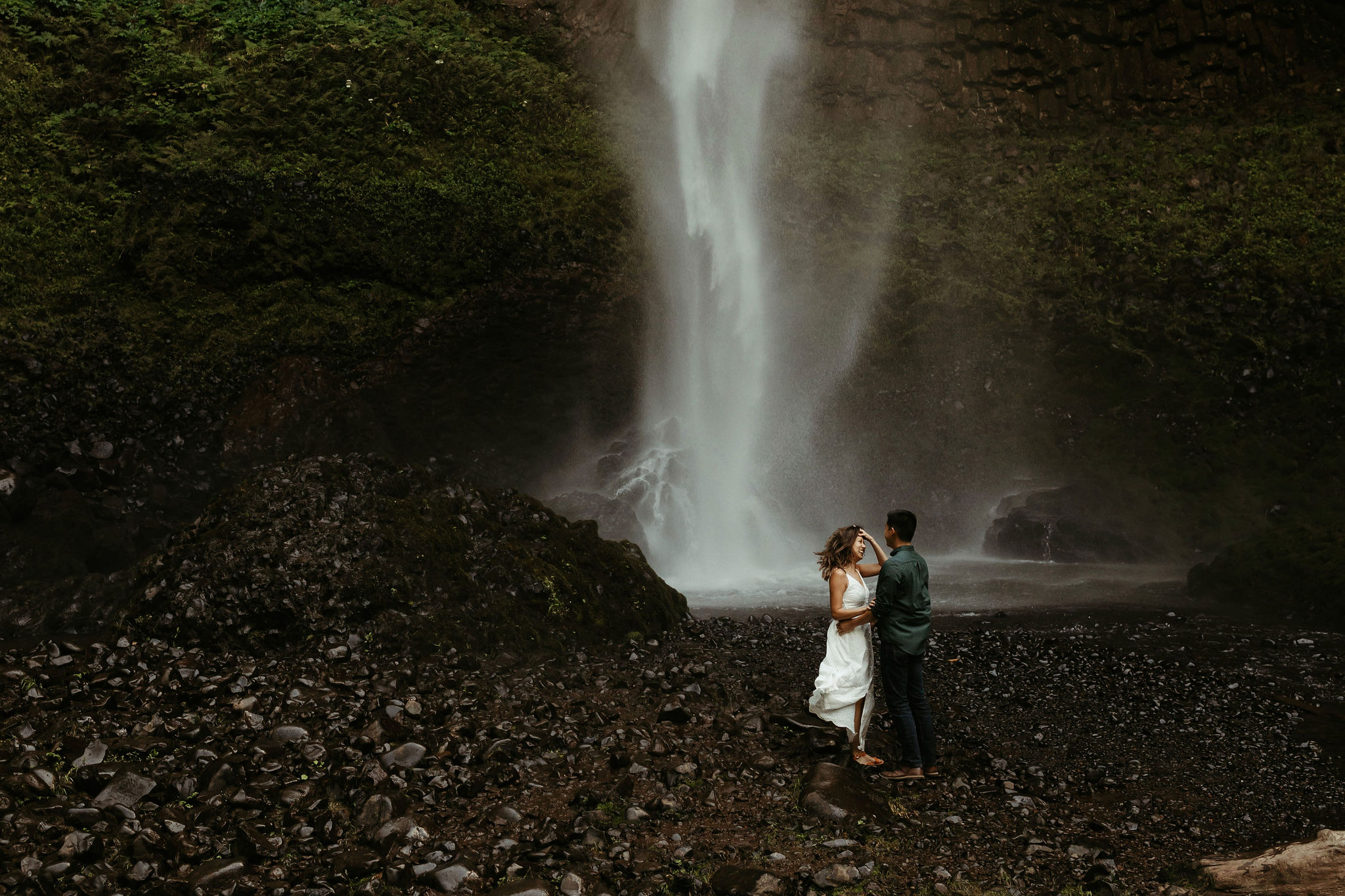 portland waterfall engagement session with bride in white summer dress and groom in dark green button up