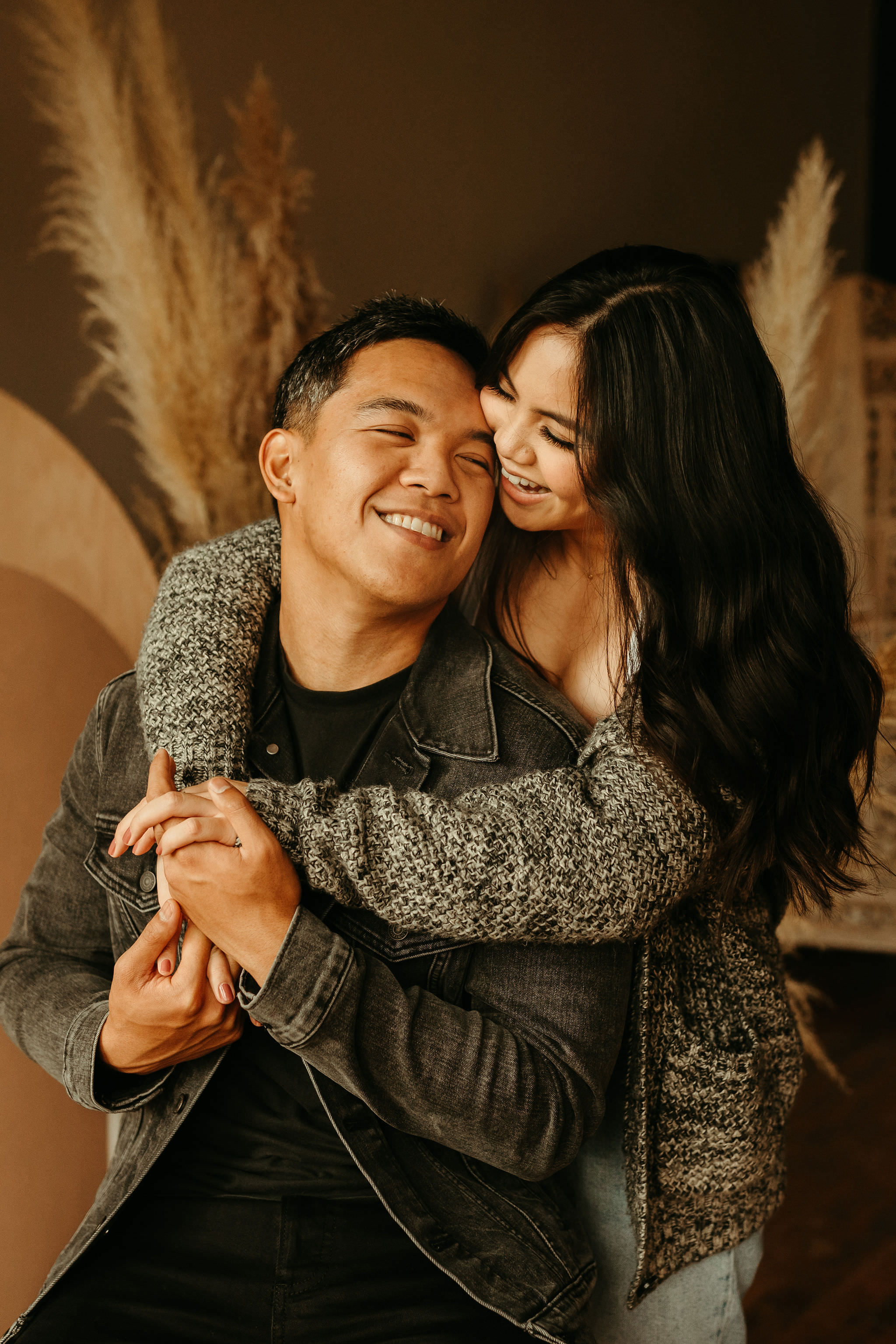 couple hugging for their indoor engagement session in seattle