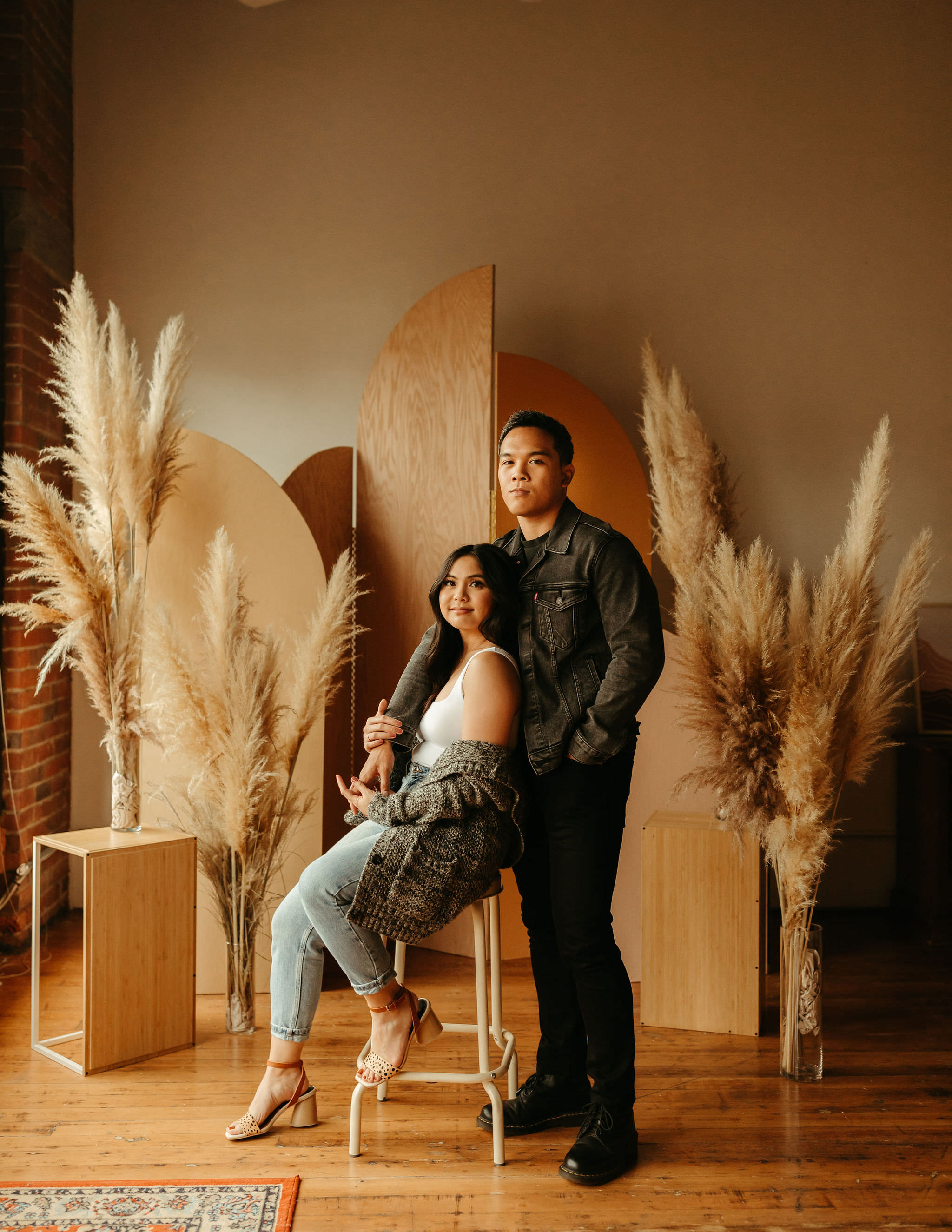 modern engagement session with arch backdrop and pampas grass